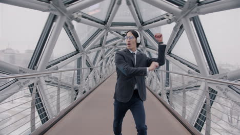 businessman dancing on a modern city bridge