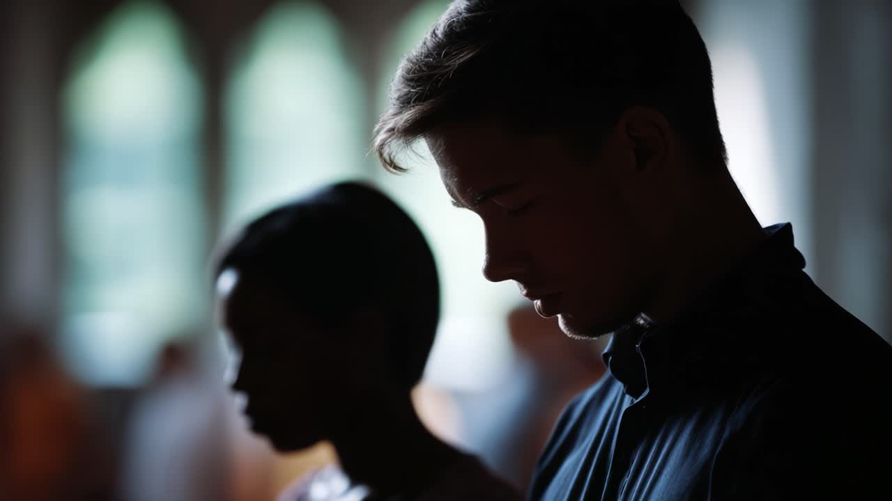 A Moment of Reflection: Two Individuals Engaged in Contemplation in a Dimly Lit Space with Rays of Light Illuminating Their Profiles