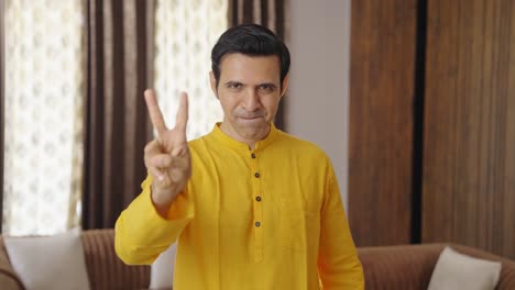 Happy-Indian-man-showing-victory-sign