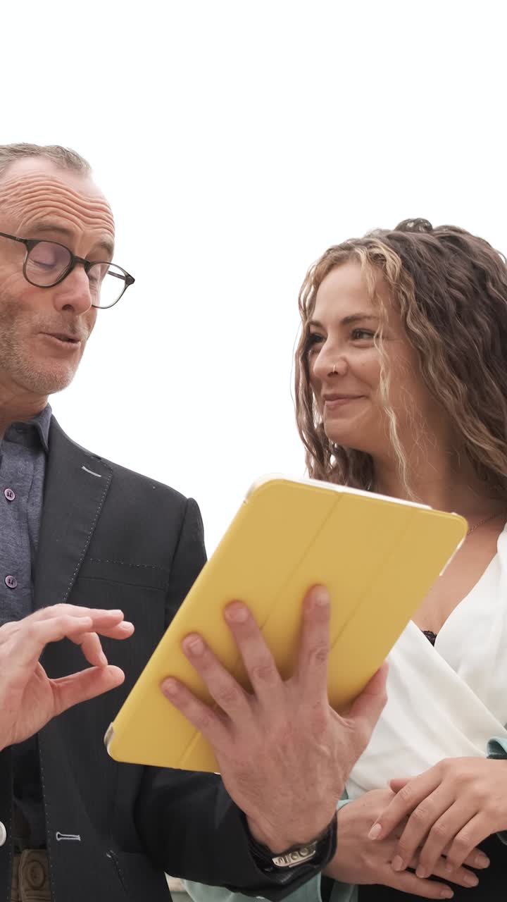 Business team collaborating using touchscreen tablet. Vertical