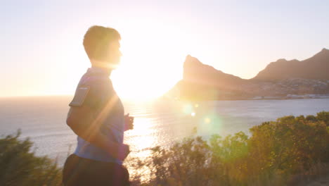 young man running on an empty coastal road