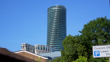 a tall skyscraper with apartments and offices in