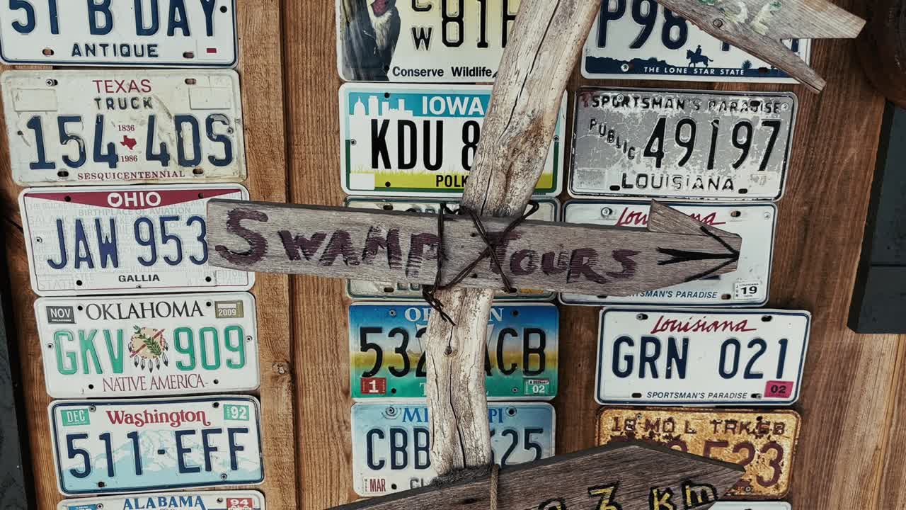 Collection of Vintage License Plates and Rustic Swamp Tours Sign