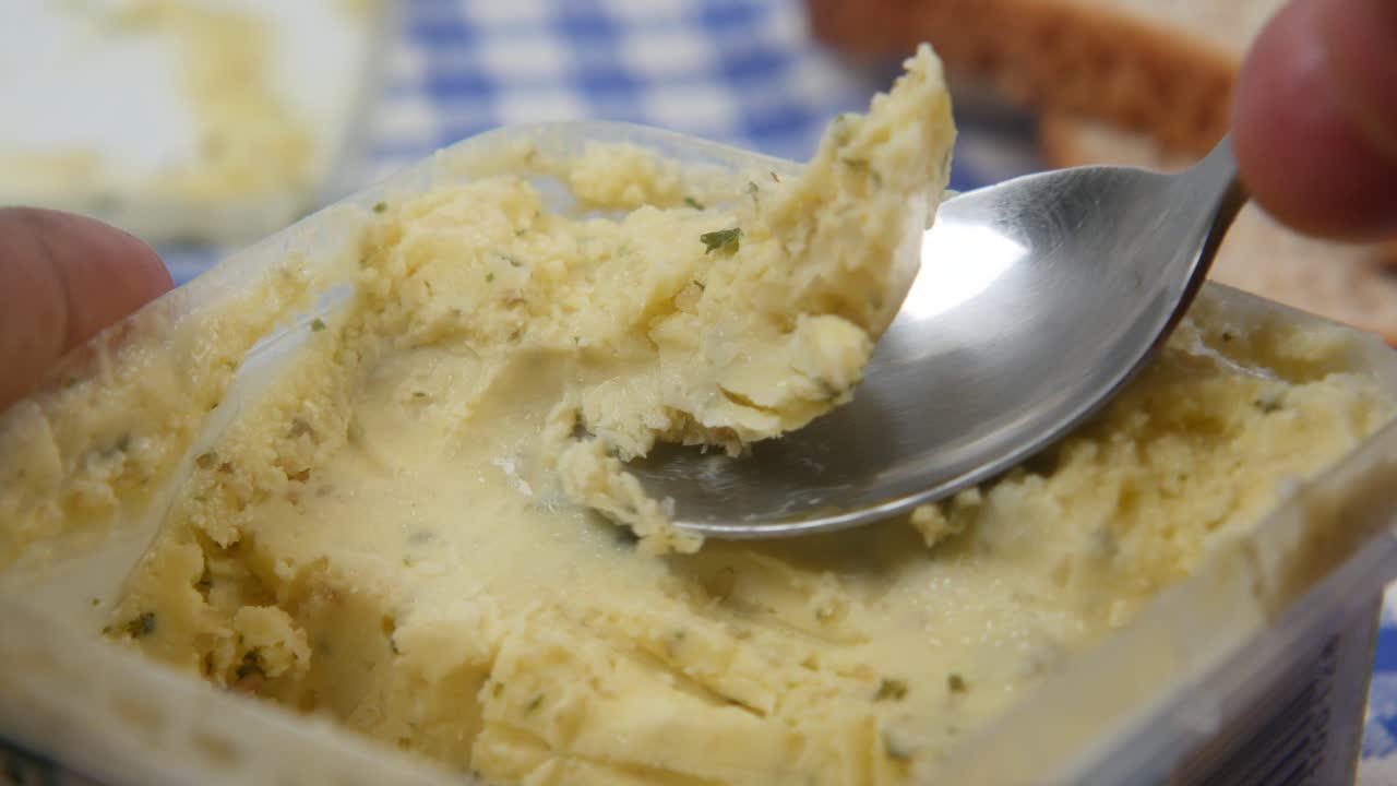 Spoon pick garlic butter spread ,