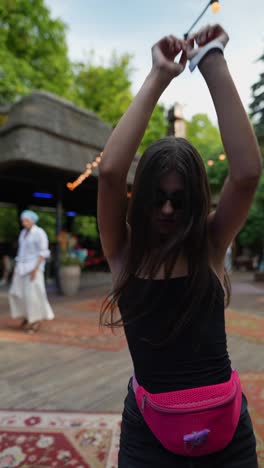 happy young woman dancing at a summer festival