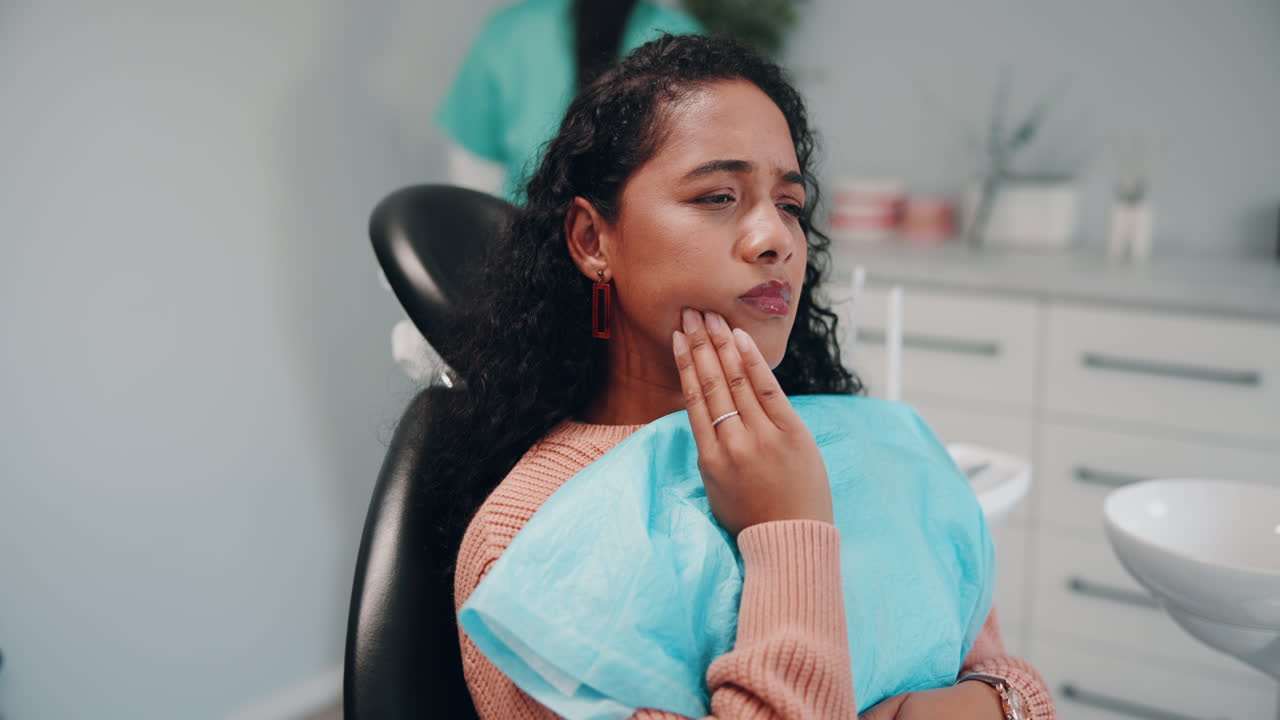 Woman in a dentist chair with a toothache