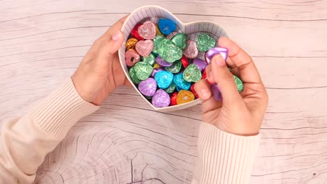 colorful chocolate hearts in a heart-shaped box