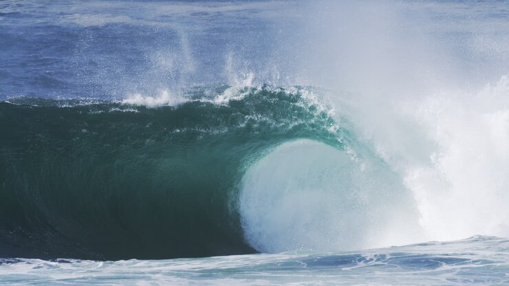 Crashing ocean wave with rising mist and glowing texture, shot in slow motion