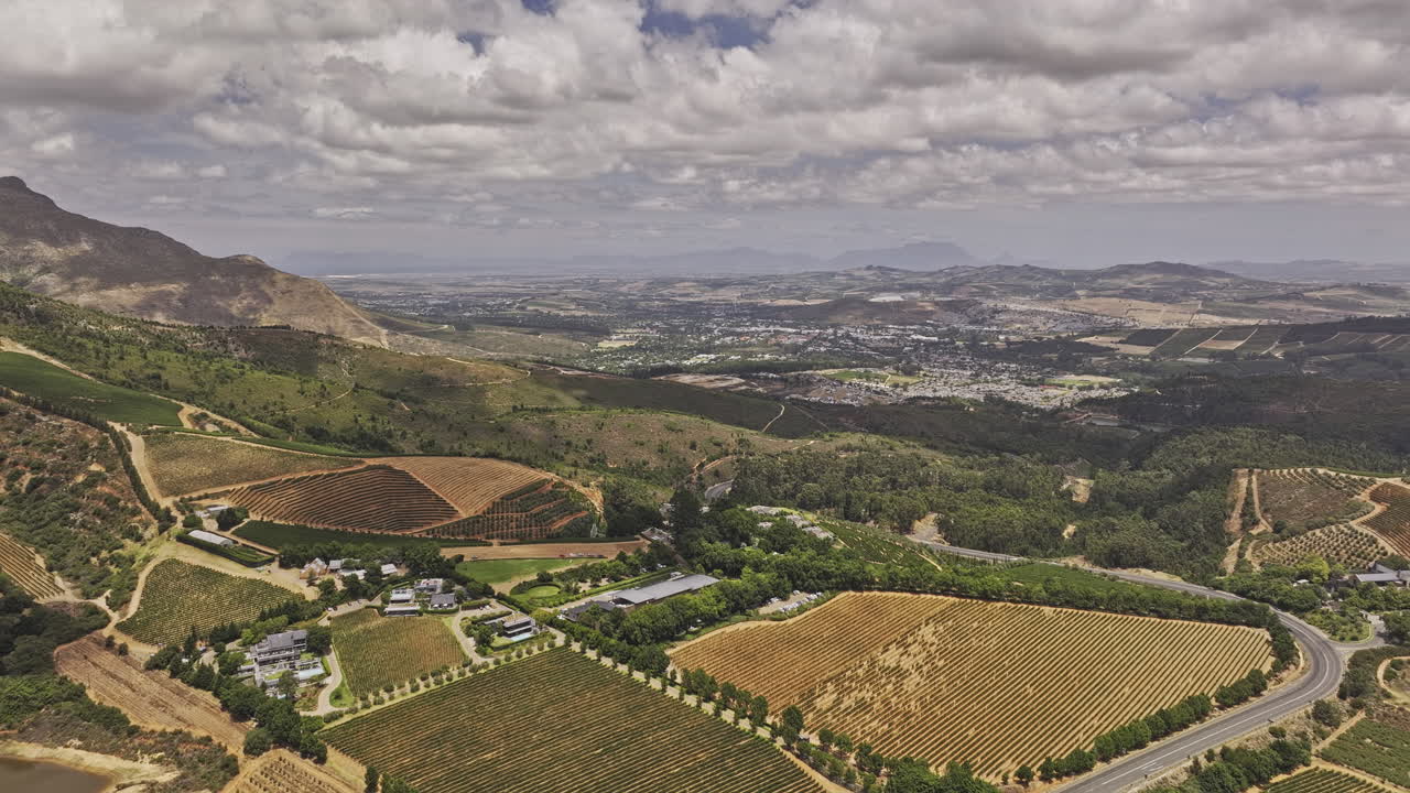 Stellenbosch South Africa Aerial v2 flyover Delaire Graff Wine Estate capturing lush hillside vineyards, views of mountain landscape and townscape - Shot with Mavic 3 Pro Cine - Jan 6th 2024