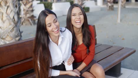 two young women sharing a good joke