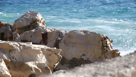 close-up of foamy waves of the adriatic sea crashing against the shore of an albanian beach