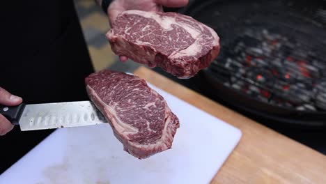 preparing ribeye steaks on the grill