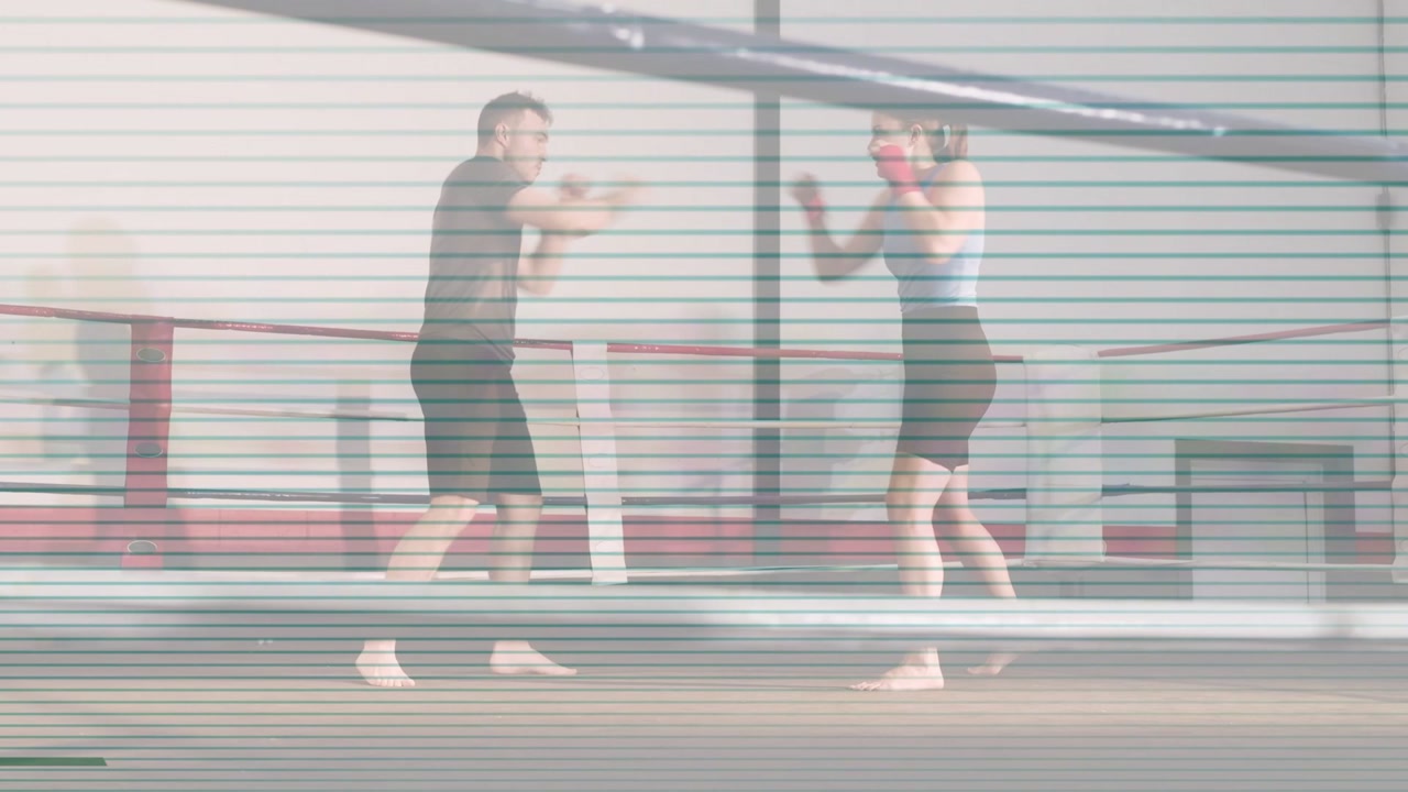 Coach gesturing, trainee stepping and throwing jabs, training distance in boxing ring, red gloves