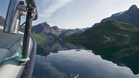 traveling in the clear river in norway background with high mountains and a cloudy sky - wide shot