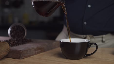 Pouring-freshly-brewed-coffee-into-a-cup