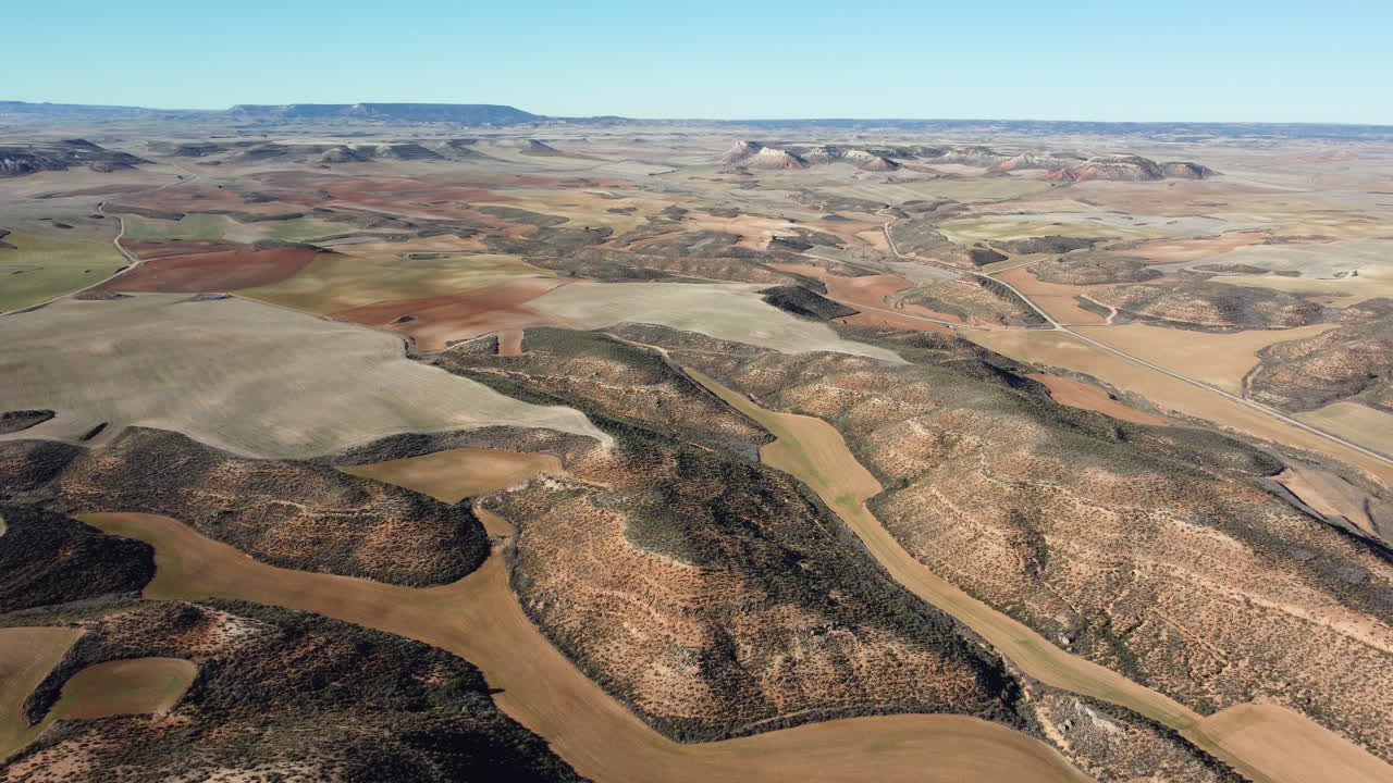 Aerial view of a colorful landscape with fields and hills