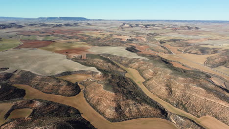aerial view of a colorful landscape with fields and hills