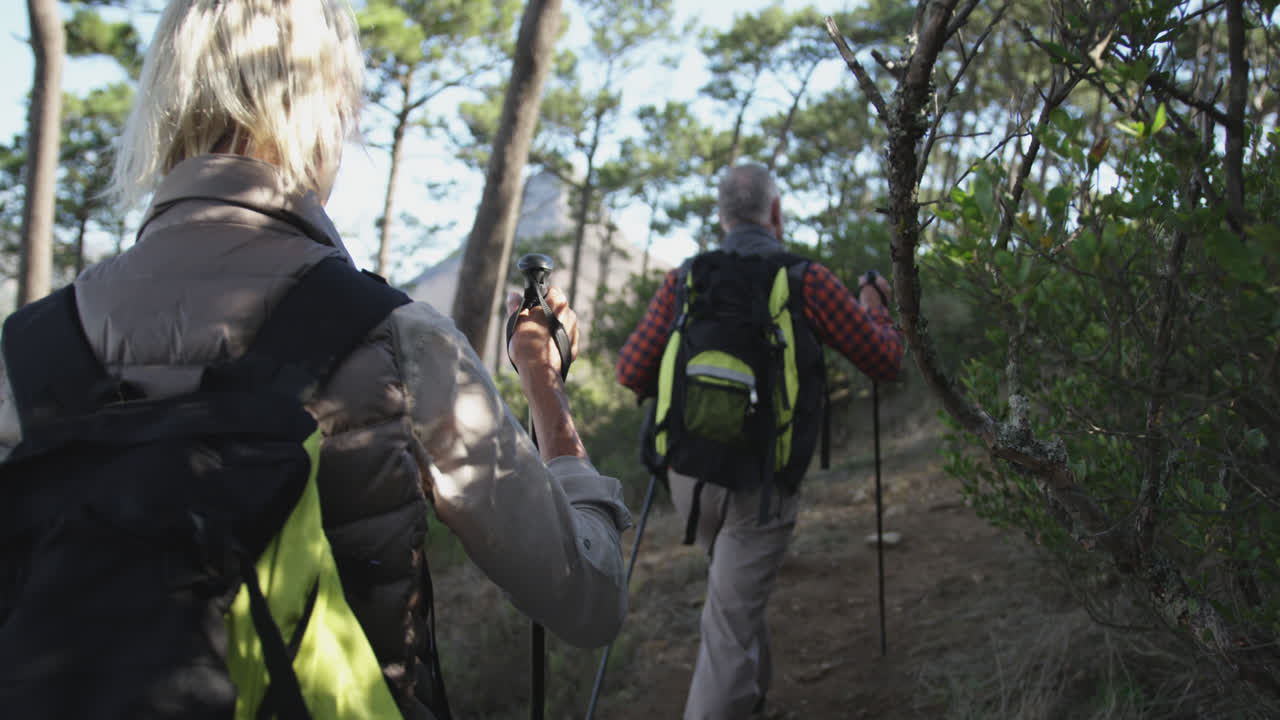 активная старшая пара гуляет по горам