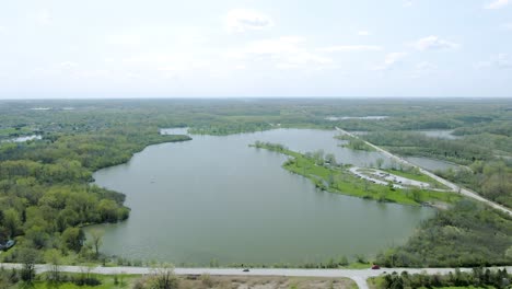 Aerial-forward-moving-motion-at-high-altitude-over-Tampier-Slough-lake-in-western-suburbs-of-Chicago,-Illinois-near-Lemont