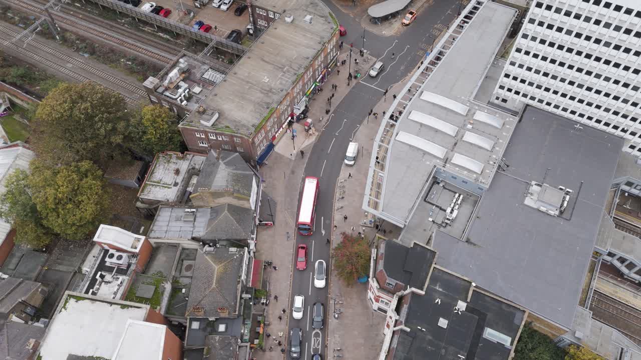 Orbital aerial shot circling The Broadway thoroughfare and surrounding urban infrastructure near Ealing Broadway Station, London, UK, October 2024