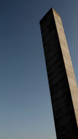 tall concrete architectural structure against a clear sky
