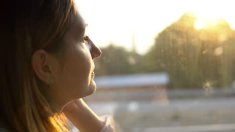 close-up side view - young charming woman enjoying the view of beautiful nature on a sunny day