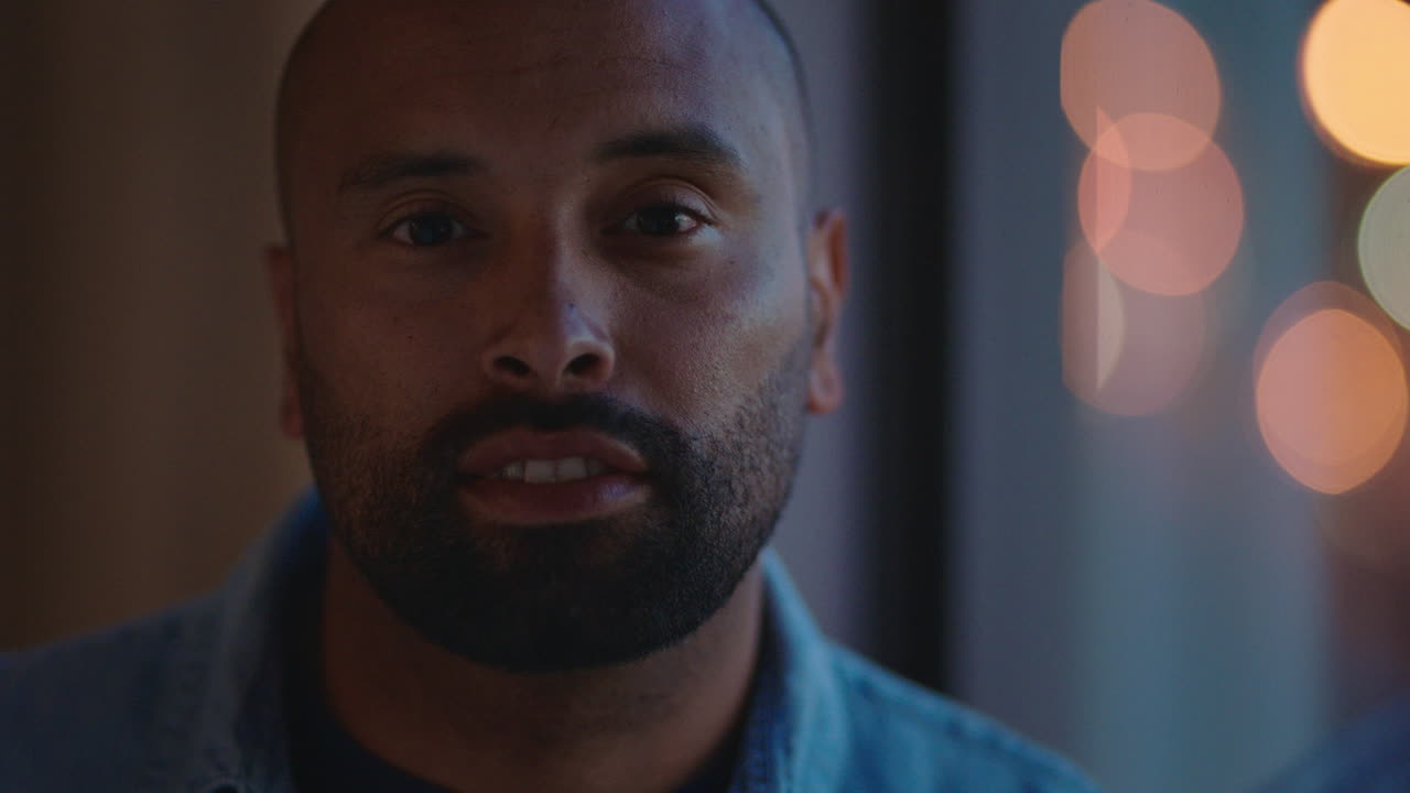 portrait of attractive man smiling relaxing at home enjoying calm evening