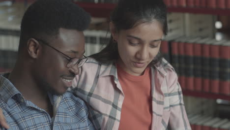 pretty girl and handsome black boy studying in the library 2