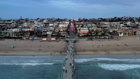 Panoramic-aerial-forward-panning-drone-shot-of-Manhattan-Beach-Pier-overlooking-the-city-Manhattan-Beach-Los-Angeles-California