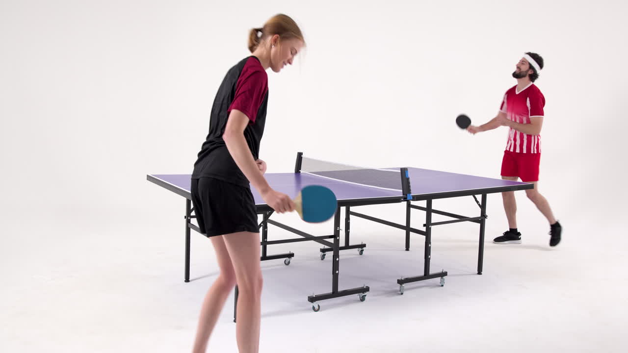 Playing table tennis, two people enjoying game in indoor setting