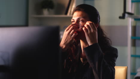 woman applying eye patches in office