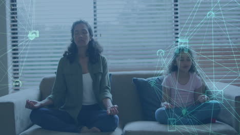 animation of green network of media icons over mother and daughter meditating on couch at home