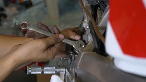 Close-up-Footage-of-Mechanic-Working-On-Installing-Brake-Cable-For-Motorcycle