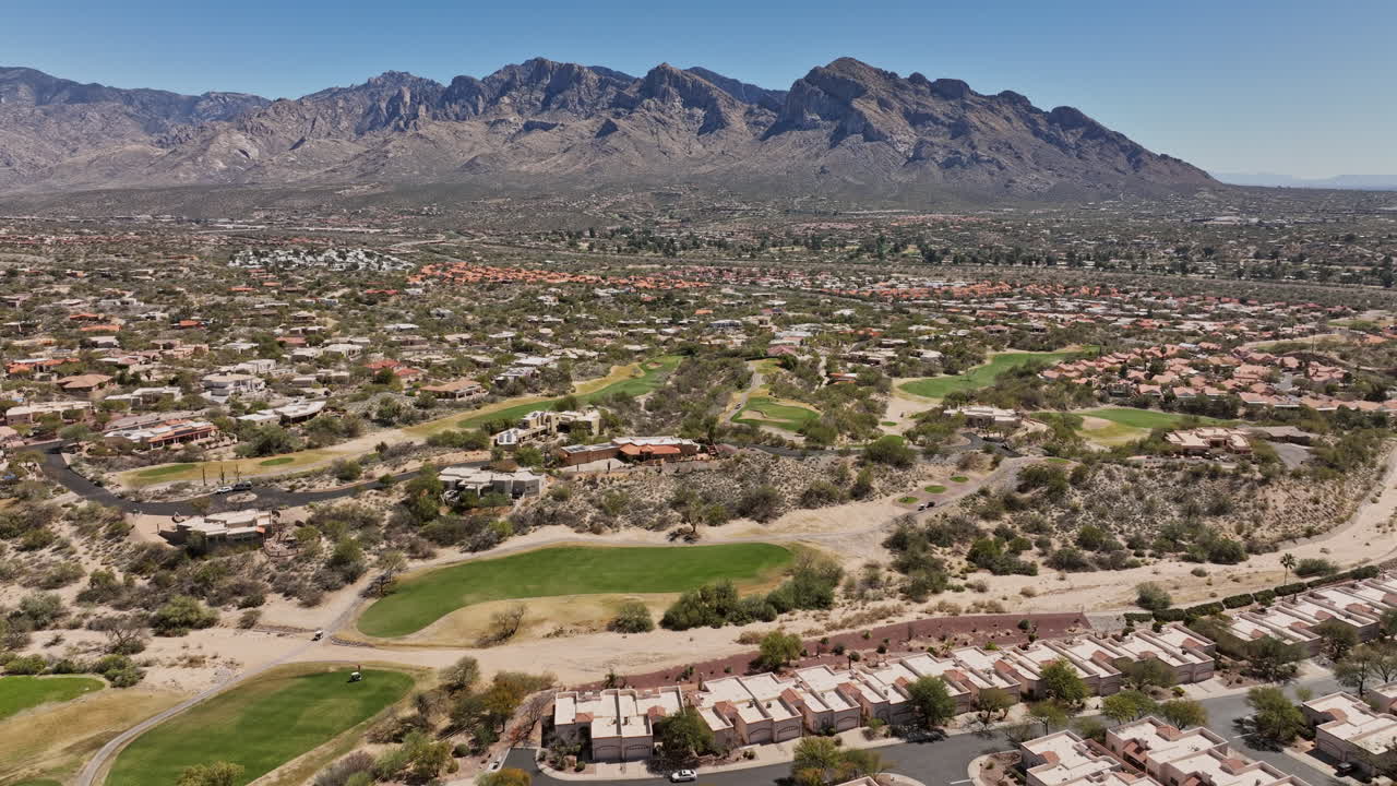 Tucson Arizona Aerial v5 flyover Oro Valley Canada Hills neighborhoods capturing spectacular mountainscape, El Conquistador Golf course and tennis courts - Shot with Mavic 3 Cine - March 2022