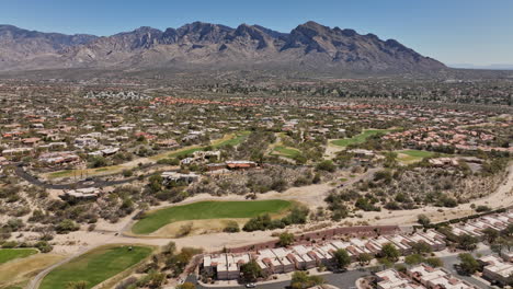 Tucson-Arizona-Aerial-v5-flyover-Oro-Valley-Canada-Hills-neighborhoods-capturing-spectacular-mountainscape,-El-Conquistador-Golf-course-and-tennis-courts---Shot-with-Mavic-3-Cine---March-2022
