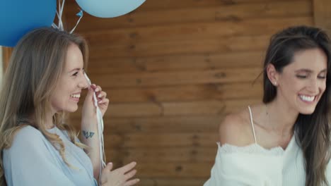 group of caucasian women giving gifts to friend in pregnant.