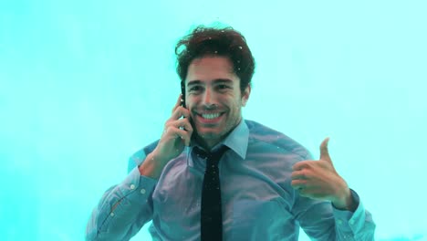 smiling man having a phone call underwater