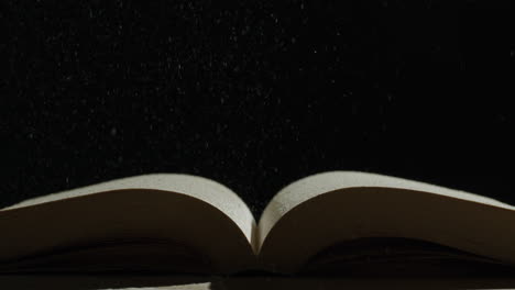 open book with particles