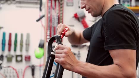 Anonymous-mechanic-cleaning-bicycle-fork-with-air-blow-gun