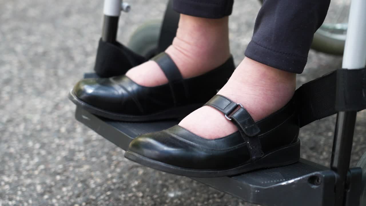 Elderly hands holding a bouquet of colorful flowers wrapped in paper