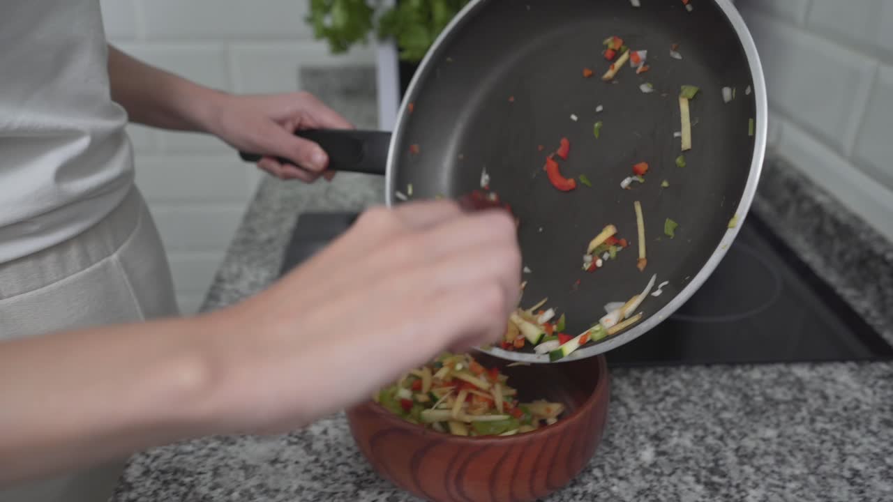 Woman preparing a vegetable dish in the kitchen