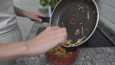 woman preparing a vegetable dish in the kitchen