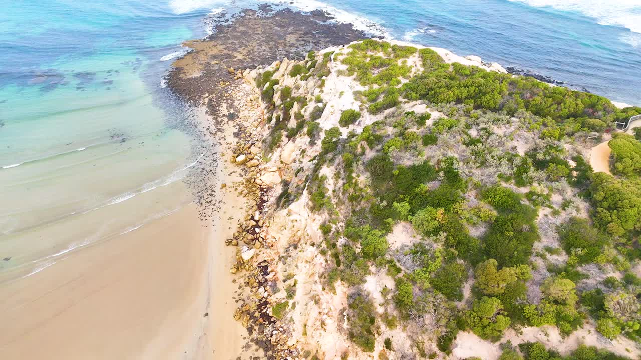 Drone footage captures the rugged coastline and clear waters of Barwon Heads, showcasing natural beauty and dynamic ocean waves