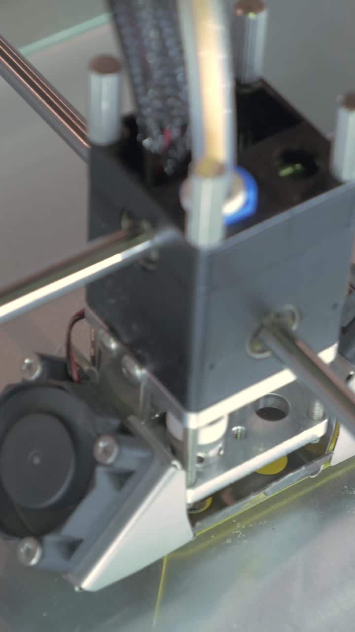 Close-up of 3D Printer Creating Yellow Plastic Object