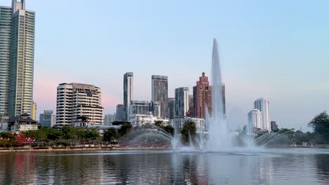 fountain show with city skyline backdrop