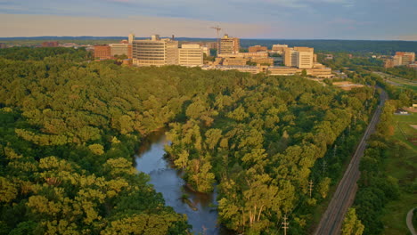 drone capturing slow aerial footage above the huron river in ann arbor, michigan, in summer.