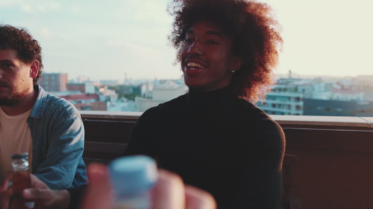 Friends socializing on a rooftop at sunset