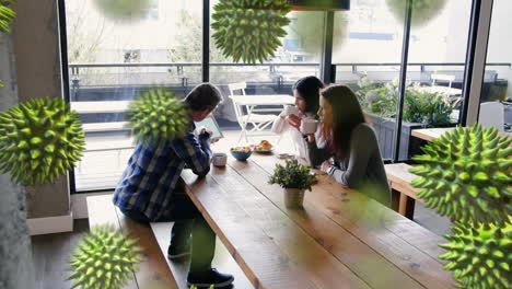 animation of macro coronavirus covid-19 cells spreading over caucasian people taking a breakfast