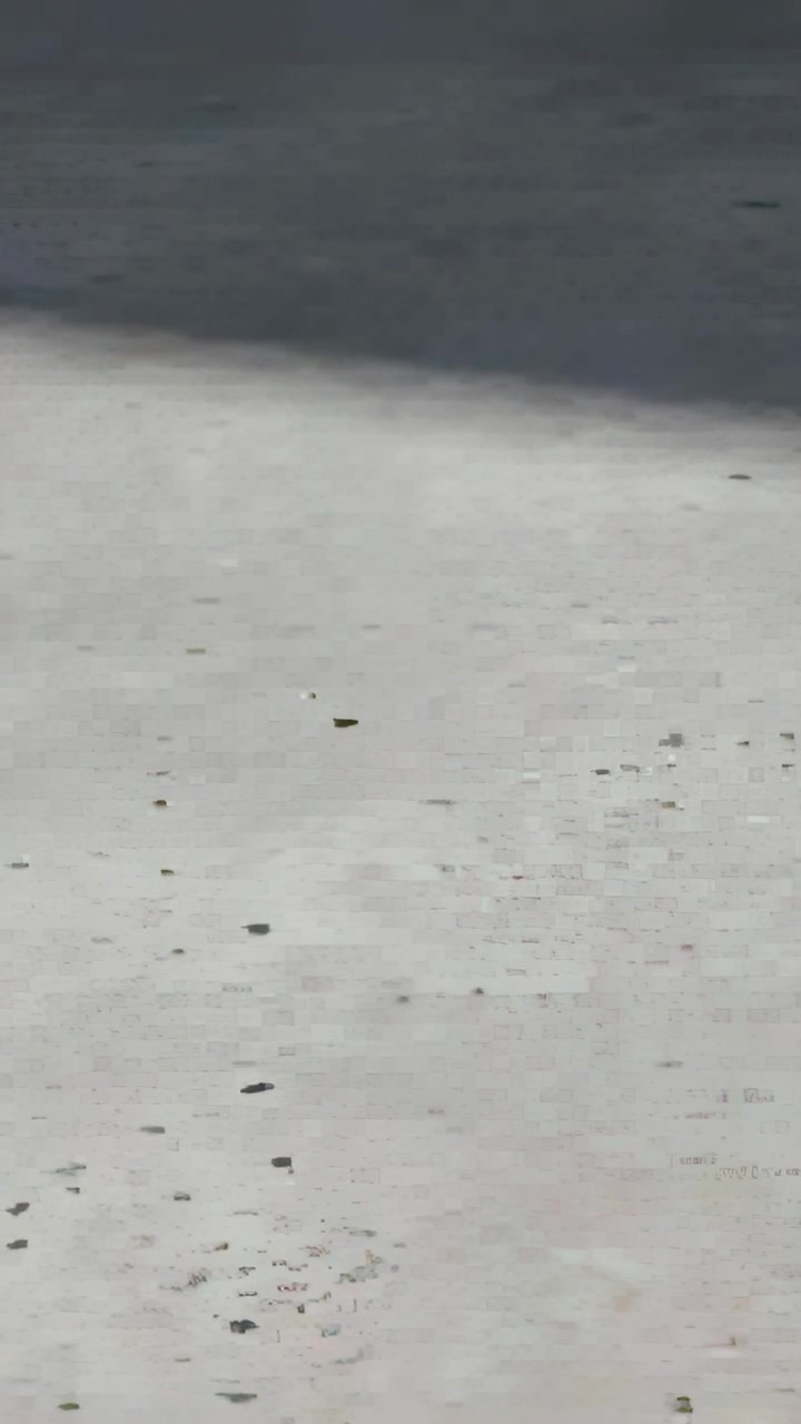 Vertical video: Stabilizing camera panning and filming pavement outdoors showing sharp shadow, grit