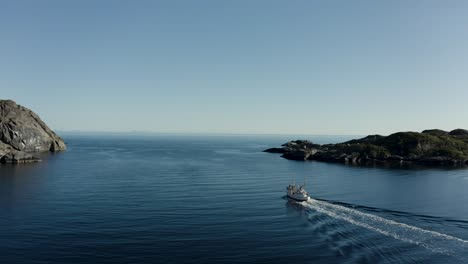 aerial drone shot of fishing boat heading out to the ocean